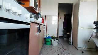 Sexy wife having fun in the kitchen with roses.