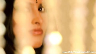 Olive sari with a gold border frames her eyes