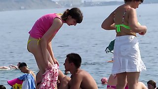 strange white woman sunbathes flashing ass in lowered bikini