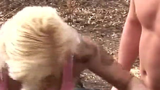 Mature blonde woman in fishnet fucked on the log