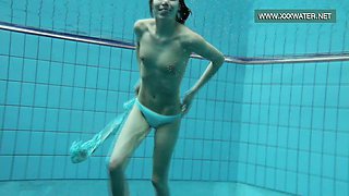 Podvodkova swimming in blue bikini in the pool