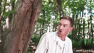 Headphones and tank top tease before she bends over in the woods
