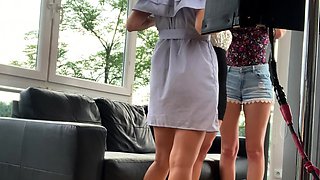 In a kitchen a sexy brunette playing with her big boobs