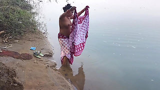 Indian village wife bathing in the river in outdoor area