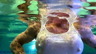 Amazon Kandy Flexes Her Massive Biceps in Her Hotel Pool