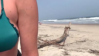 Busty MILF In Green Bikini Handjobs Her Partner On A Public Beach