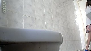 Tall and sexy white young babe in the toilet room filmed on hidden cam