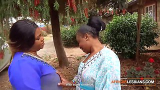 Big-Titted African Lesbians Kiss in Public at House Party