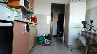 Sexy wife having fun in the kitchen with roses.