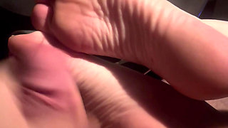 Sexy redhead gets a hot load of cum on her feet and soles in the car after drinks at the bar.