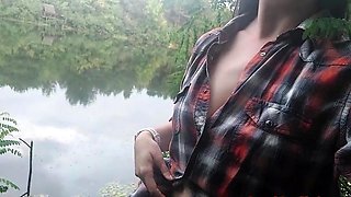 Brunette teen masturbates by the lake